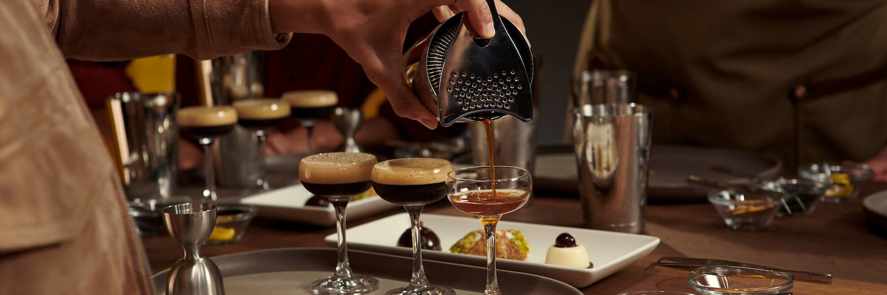 person pouring espresso martini